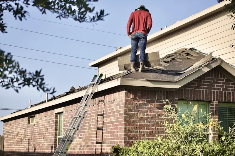 Professional roofer working on a residential roof in Royal Elm